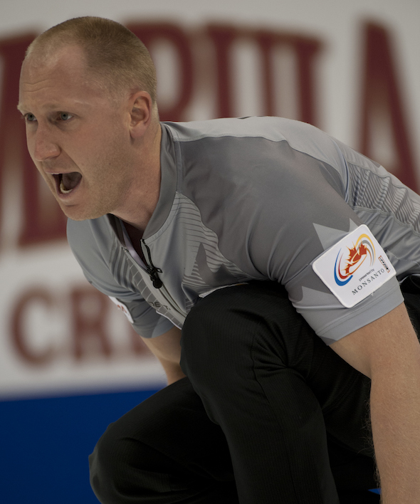 Brad Jacobs urges on his sweepers during his win over Jeff Stoughton on Sunday night. (Photo, CCA/Michael Burns)