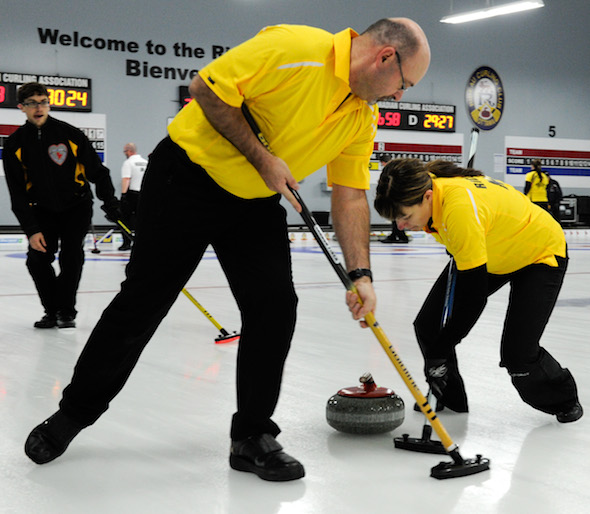 New Brunswick third Marcel Robichaud, left, guides sweepers Lloyd Morrison, middle, and Marie Richard during Wednesday's game at the Canadian Mixed. (Photo, CCA/Claudette Bockstael, Studio C Photography)