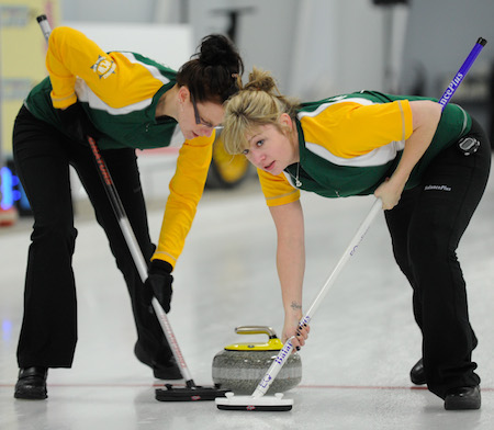 Northern Ontario sweepers Alissa Begin, left, and Lindsay Miners scrub a rock during Sunday afternoon's game. (Photo, CCA/Claudette Bockstael, Studio C Photography)