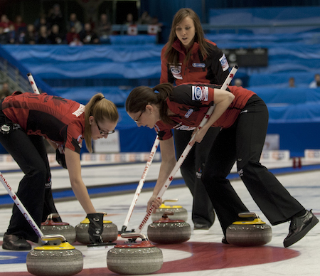 Team Canada skip Rachel Homan, top, instructs sweepers Alison Kreviazuk, left, and Lisa Weagle. (Photo, CCA/Michael Burns)