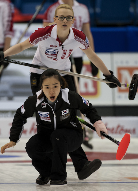 Saint John N.B.Mar22_2014.Ford World Woman's Curling Championship.Korea skip ji-Sun Kim,Russia second Anna Saitova.CCA/michael burns photo
