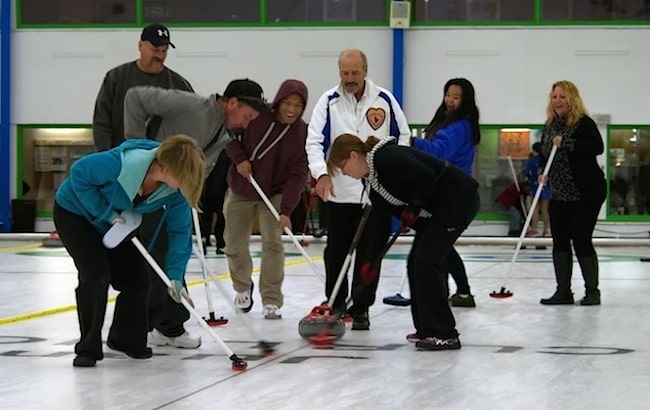 Coaches are on the ice to help novice curlers during the Open House at Juan de Fuca Curling Centre (Photo Doug Butler)