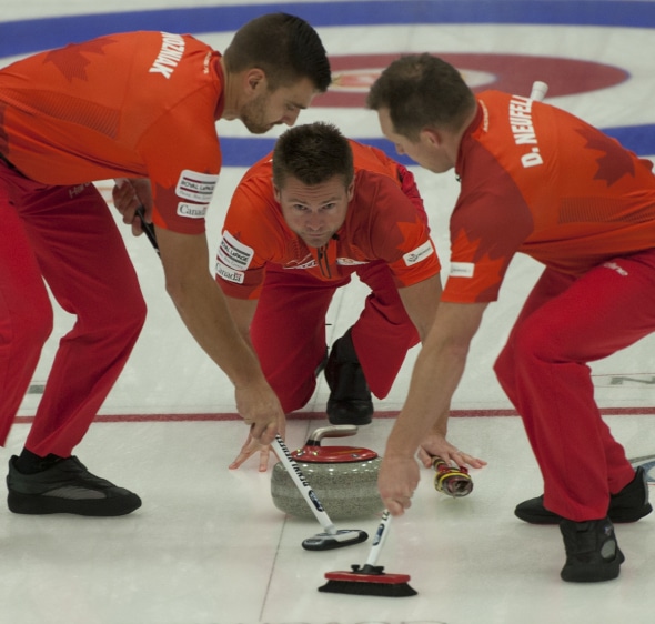 Skip Mike McEwen, along with teammates Matt Wozniak, left, and Denni Neufeld have continued their hot pace this week in Yorkton, Sask. (Photo, CCA/Michael Burns)