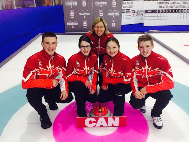 Team Canada poses on the ice with their new gear (l-r): Tyler Tardi, Mary Fay, coach Helen Radford, Karlee Burgess and Sterling Middleton (Curling Canada photo)