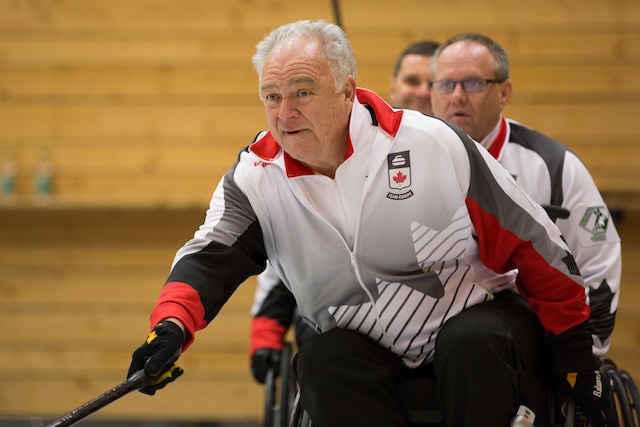 Skip Jim Armstrong focuses on his shot at the 2016 World Wheelchair Curling Championship in Lucerne, Switzerland (WCF/Céline Stucki)