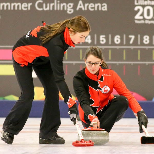 Canadian skip Mary Fay delivers her rock while second Karlee Burgess prepares to sweep at the 2016 Youth Olympic Games in Lillehammer, Norway (WCF/Richard Gray photo)
