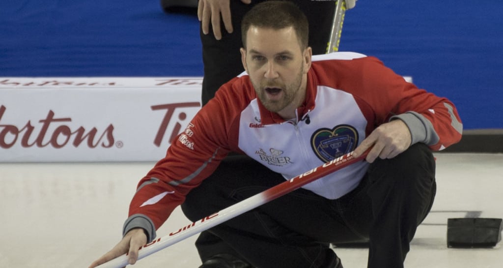 Ottawa Ont.Mar 9; 2016.Tim Hortons Brier.N.L. skip Brad Gushue (foreground) studies the incoming stone as Team Canada skip Pat Simmons checks the stones line.Gushue defeats Simmons 7-3 in 9 ends. michael burns photo