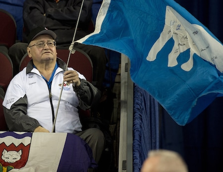 Fred Koe cheers on the Northwest Territories during Friday's win. (Photo, Curling Canada/Michael Burns)