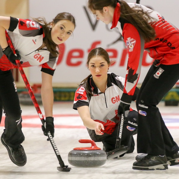 Team Canada lead Janique LeBlanc and third Kristin Clarke get ready to sweep second Karlee Burgess's rock during the Gold Medal Game of the 2016 World Junior Curling Championships in Taarnby, Denmark (WCF/Richard Gray photo)