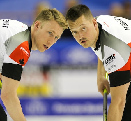 Team Canada's Marc Kennedy, left, and Ben Hebert look for instructions. (Photo, World Curling Federation/Céline Stuckli)