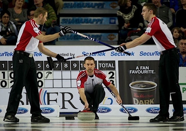 Team Gushue front end Geoff Walker (left) and Brett Gallant (right) swap brooms during action at the 2016 Tim Hortons Brier in Ottawa (Curling Canada/Michael Burns photo)