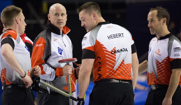 Team Canada, from left, Marc Kennedy, Kevin Koe, Ben Hebert and Brent Laing, take a break during Wednesday's loss to Sweden. (Photo, World Curling Federation/Richard Gray)