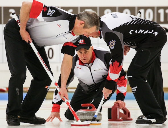 Canadian skip Randy Neufeld watches his rock as sweepers Peter Nicholls, left, and Dale Michie go to work during Friday's win over Sweden. (Photo, World Curling Federation/Céline Stucki)