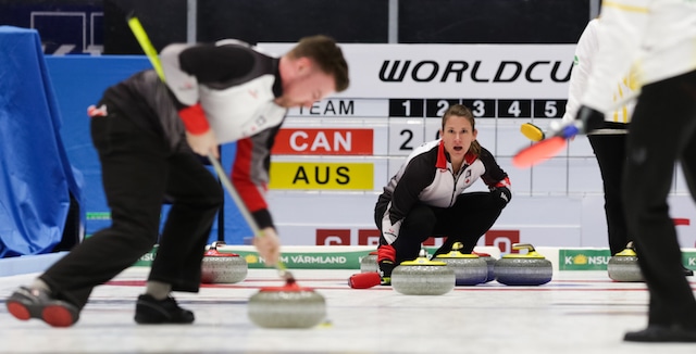 Marliese Kasner calls the line as teammate Dustin Kalthoff sweeps during action at the 2016 World Mixed Doubles Curling Championship in Karlstad, Sweden (WCF/Hamish Irvine photo)