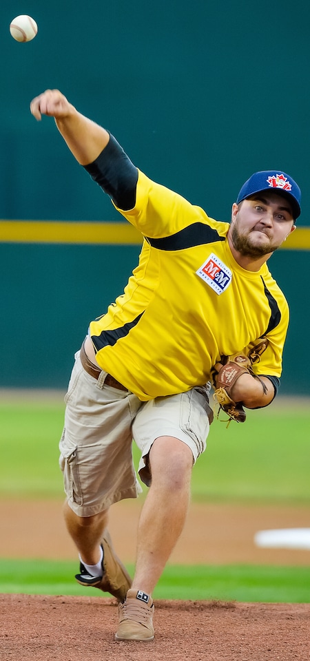 Two-time Canadian junior men's curling champ Matt Dunstone delivers the ceremonial first pitch prior to a Winnipeg Goldeyes game earlier this week. (Photo, courtesy Winnipeg Goldeyes)
