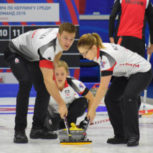 Canada's Brad Thiessen takes a look as he and Alison Kotylak sweep a shot by Sarah Wilkes at the Kazan Sports Palace during round robin play at the 2016 World Mixed Curling Championship (Photo, World Curling Federation/Alina Androsova)