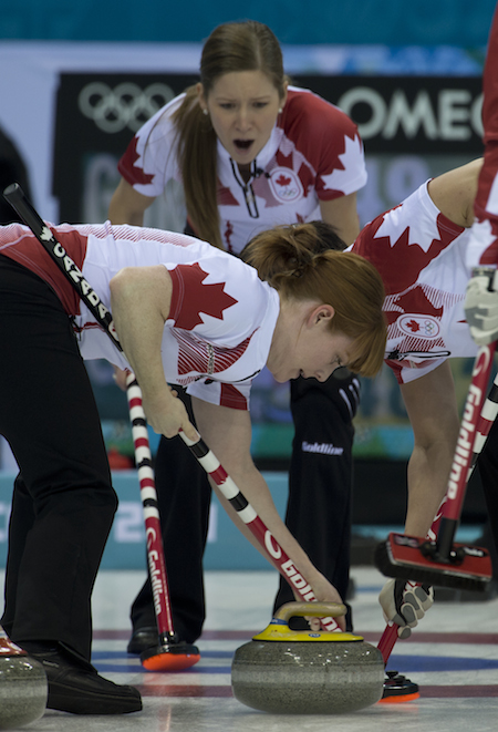 Team Canada vice-skip Kaitlyn Lawes, top, encourages sweepers Dawn McEwen, left, and Jill Officer.