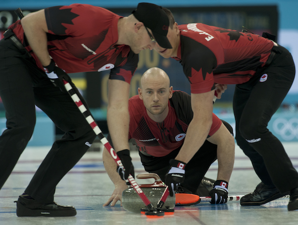 Team Canada third Ryan Fry delivers rock to sweepers Ryan Harnden, left, and E.J. Harnden. (Photo, CCA/Michael Burns)