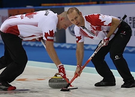 Team Canada's Nolan Thiessen, left, and Pat Simmons sweep Carter Rycroft's stone on Sunday. (Photo, World Curling Federation/Richard Gray)