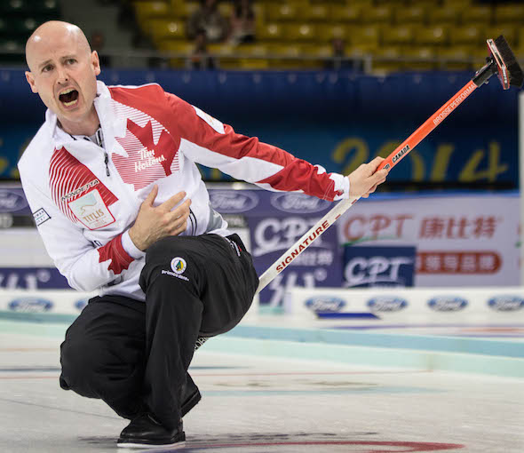 Team Canada skip Kevin Koe instructs his sweepers during the bronze-medal game. (Photo, World Curling Federation / Céline Stucki)