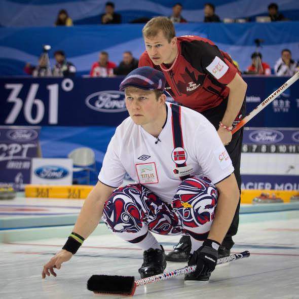 Norway's Christoffer Svae watches his shot as Canada's Carter Rycroft looks on. (Photo, World Curling Federation / Céline Stucki)