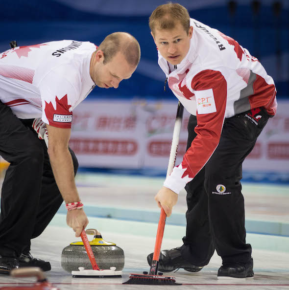 Canadian sweepers Pat Simmons, left, and Carter Rycroft keep things clean. (Photo, World Curling Federation / Céline Stucki)