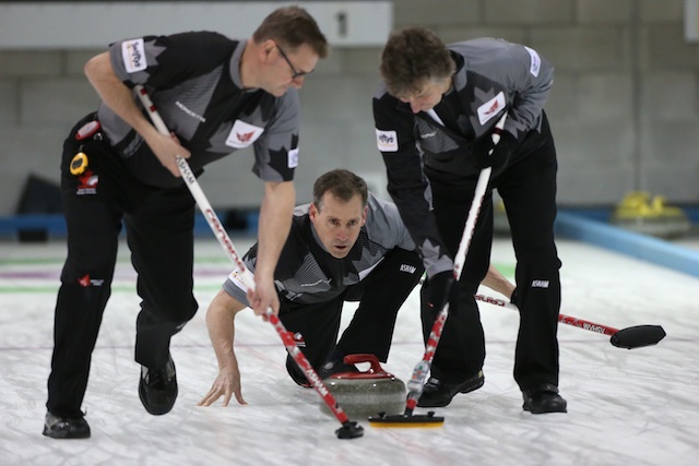 Canadian skip Wayne Tallon delivers his rock to sweepers Wade Blanchard (left) and Mike Flannery (right) (Photo WCF/Richard Gray)