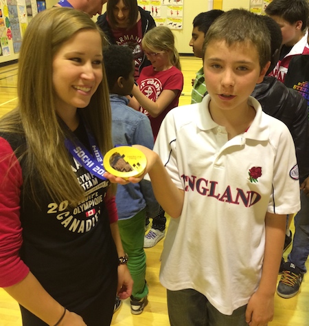 A student at St. Anthony's School in Calgary finds out just how heavy those Olympic gold medals really are! (Photo: CCA)