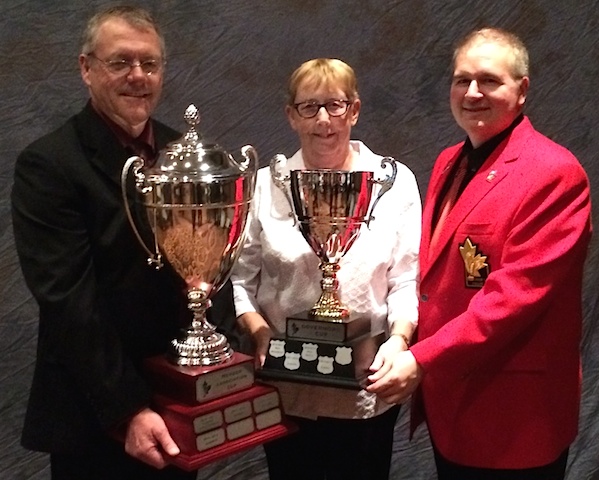 (From left) Dan Kleinschroth, past-president of the Alberta Curling Fed., Joan Westgard, current president of the ACF, and Hugh Avery, Chair of the CCA Board of Governors with the MA Cup, presented by TSN, and the Governors' Cup. (CCA Photo)