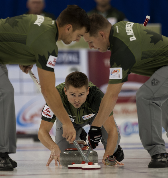 Mike McEwen, backed up by teammates Matt Wozniak, left, Denni Neufeld, right, and B.J. Neufeld (not shown) won a World Curling Tour event on the weekend in Oakville, Ont. (Photo, CCA/Michael Burns) 